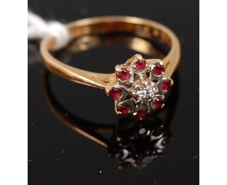 An 18ct gold, ruby and diamond flower head cluster ring, 2.7g, size N