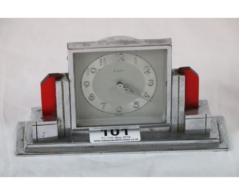 Art Deco 8 day mantel clock of stepped block form with translucent red bakelite pillars, raised on stepped plinth, silvered d