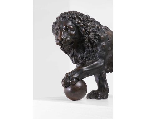 A patinated bronze model of a Medici lion, late 19th/early 20th century, after the antique, typically modelled with one paw r