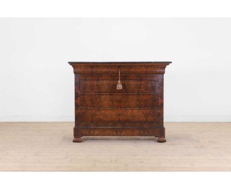 A Louis Philippe figured walnut commode, early 19th century, French, the black marble top above a cavetto-moulded frieze draw