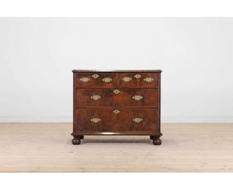 A William and Mary walnut chest of drawers, late 17th century and later, the crossbanded top above two short and two long dra