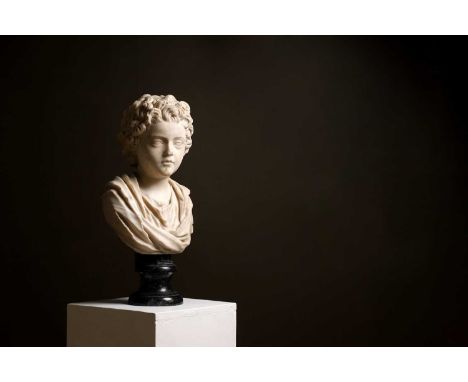 A Roman marble portrait bust of an Antonine prince, c.140 CE, depicted as a boy, his head turned slightly to dexter, with thi