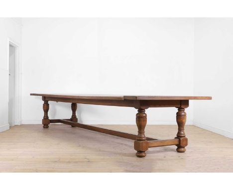 A very large oak refectory table in the 17th-century style, 20th century, with a cleated plank top, raised on baluster suppor