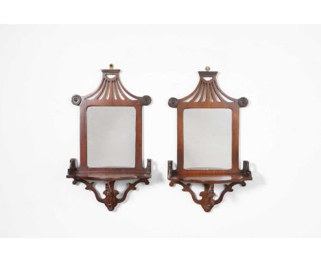 A pair of mahogany wall mirrors, 20th century, each with a pagoda-shaped top over a rectangular plate and single shelf,29cm w