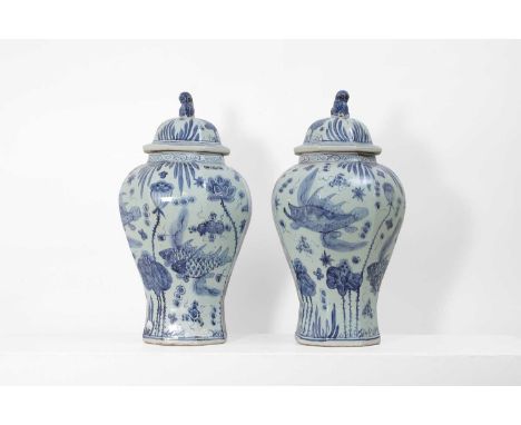 A pair of blue and white porcelain vases and covers, 20th century, Chinese, each of octagonal faceted form decorated with fis