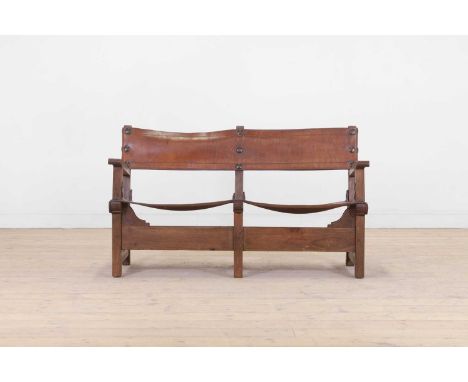 An oak and leather settee, c.1930, Spanish, with a studded back and seat, on square supports, 107cm wide57cm deep71cm high