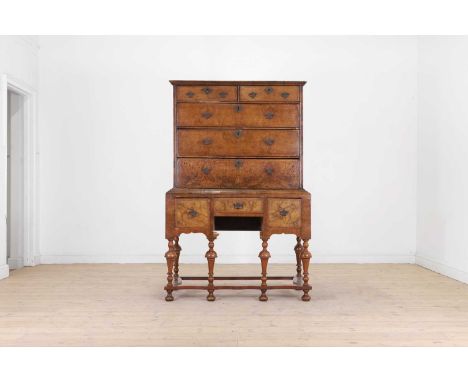 A walnut chest on stand, 18th century and later, the upper section fitted with two short over three long drawers, above three