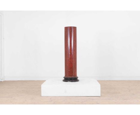 An imitation rosso antico scagliola column, 19th century, of cylindrical form and raised on an ebonised stepped base,35cm dia