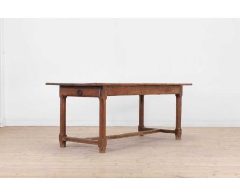 A fruitwood kitchen table, 19th century, French, the plank top on chamfered stretchered supports, 189cm long75cm wide 73cm hi