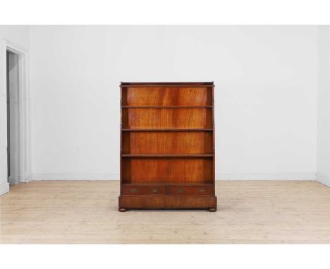 A mahogany waterfall bookcase, 19th century, with recessed brass handles, a secret cupboard to the reverse accessed from the 