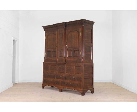 A George III North Country oak press cupboard, late 18th century, with panelled cupboard doors set between quarter column pil