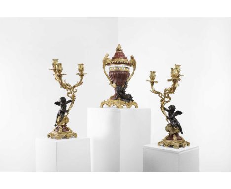 A gilt-bronze and rouge marble three-piece clock garniture, late 19th century, French, the urn with twin annular chapter ring