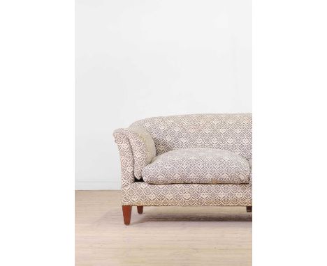A two-seater sofa by Howard & Sons, first quarter of the 20th century, with an arched back and outswept arms, with siège de d