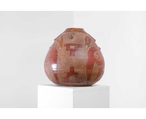 A large terracotta vase, 20th century, South American, Brazilian, with incised and sculpted decoration with masks, geometric 