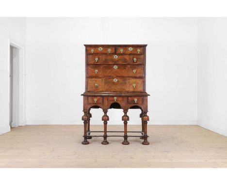 A William and Mary walnut and feather-banded chest on stand, early 18th century and later, the rectangular top above two shor