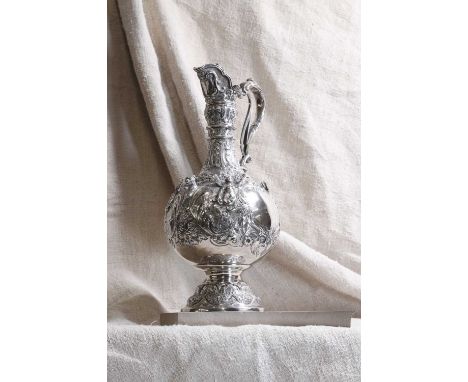 A Victorian silver Armada pattern claret jug, by Martin, Hall &amp; Co., Sheffield 1893, of typical form with a trigger-actio