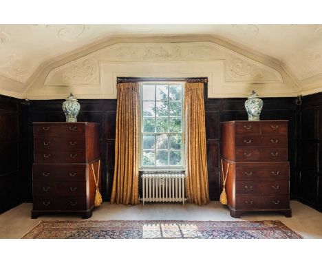 A pair of George III mahogany chests on chests, c.1770, each fitted with two short over five long drawers, with canted corner