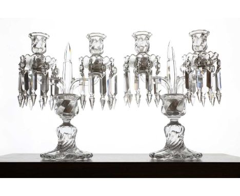 A pair of Baccarat glass candelabra, 20th century, each with a pair of candle arms supporting wrythen sconces with prismatic 