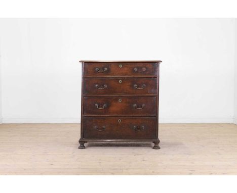 An oak chest of drawers, late 17th century, fitted with four long drawers and panelled sides, raised on bun feet,97cm wide53c