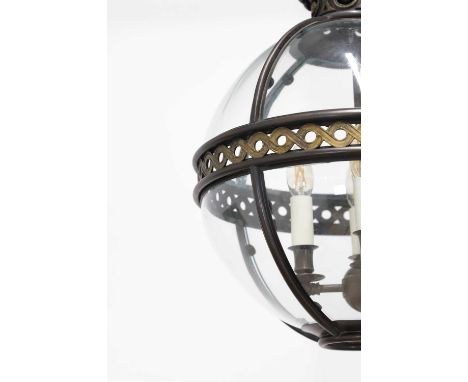A pair of bronze, gilt-brass and glass 'Original' globe lanterns by Jamb London, of recent manufacture, each with foliate fin