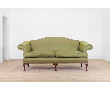 A George III-style mahogany settee, early 20th century, with a camel back and twin-cushioned seat, upholstered in green fabri