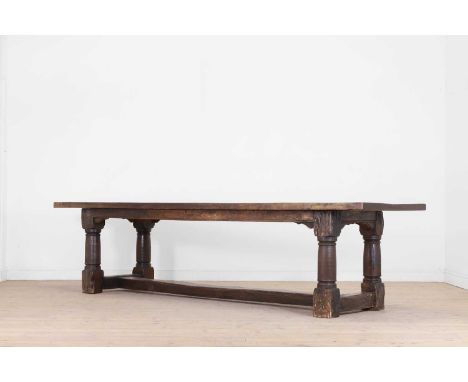 An oak refectory table,  19th century but incorporating some earlier elements, the cleated plank top above a plain frieze and