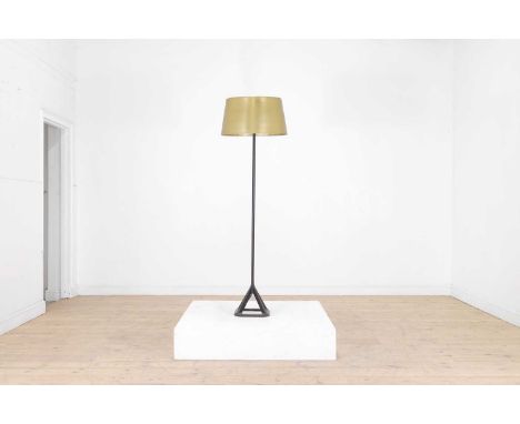 A modernist cast iron and brass floor lamp by Tom Dixon, of recent manufacture, with a tubular column and 'X' frame base, 50c