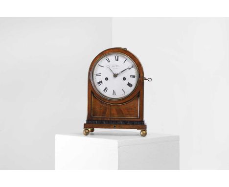 A Regency mahogany and brass-inlaid bracket clock, the arched case enclosing a white painted dial with Roman numerals inscrib