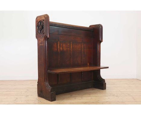 A Victorian Gothic Revival oak pew, c.1850, carved to one end with a portcullis emblem, possibly relating to the Palace of We