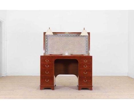 A George III-style mahogany kneehole desk by George Betjemann & Sons, c.1920, the hinged top enclosing a leather writing surf