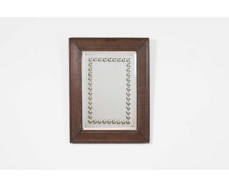 A sorcerer's mirror, 19th century, the rectangular plate with convex inclusions and soft bevel, within a moulded oak frame,35