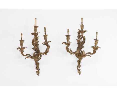 A pair of Louis XV-style ormolu wall lights, 19th century, each with three scrolling foliate branches, 52cm wide 64cm high (2