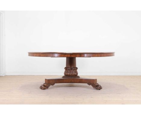 A William IV mahogany breakfast/dining table, c.1830, the circular top above a central carved column, raised on a tripod base