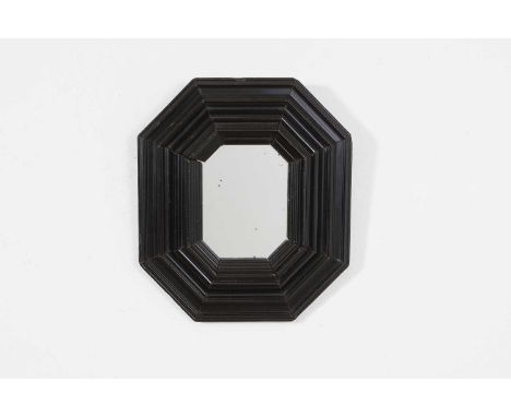 A small ebonised octagonal mirror, late 17th/early 18th century, Dutch, the mirror plate surrounded by a moulded frame, 20cm 