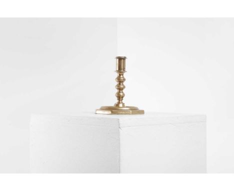 A brass candlestick, 17th century, Spanish, the knopped stem above an octagonal base, 12cm wide12cm deep14cm high