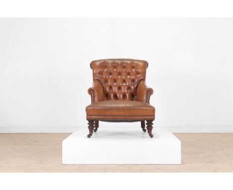 A small late Victorian buttoned leather armchair, c.1890, raised on ring-turned front supports, 69cm wide90cm deep83cm highCo