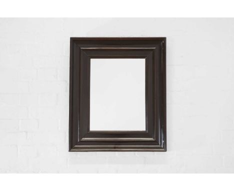 An ebonised pearwood mirror, 17th century, Dutch, with a cavetto frame enclosing a later glass plate, 59cm wide70cm highCondi