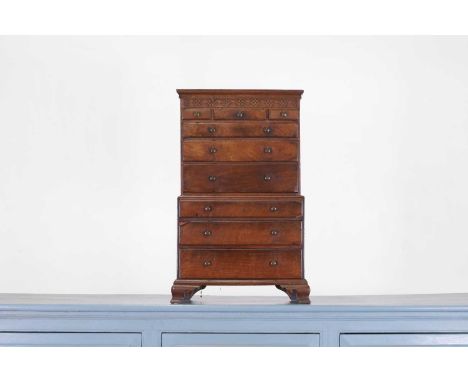 A George III mahogany miniature chest on chest, late 18th century, with a blind fret frieze, above three short and six long d
