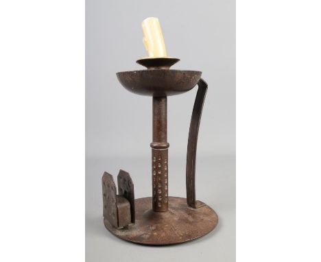 A hand planished iron arts and crafts candlestick with integral match holderHx18cm