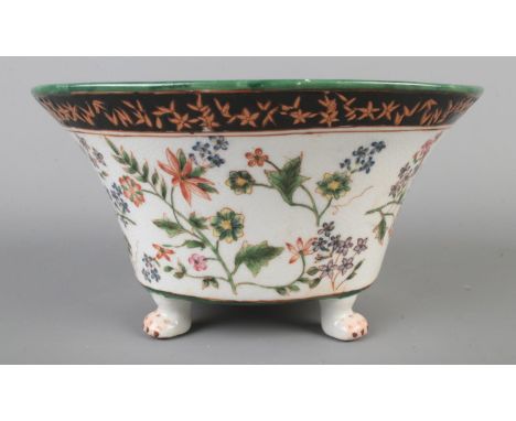 A Wong Lee ceramic centerpiece/planter bowl featuring hand painted floral decoration and raised on paw feet.