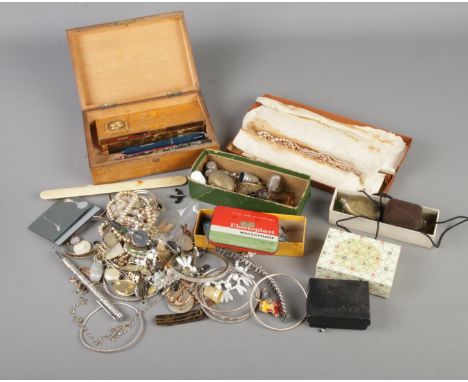 A box of assorted costume jewellery and collectables to include Robertsons Golly pin badge, thimbles including Sheffield silv