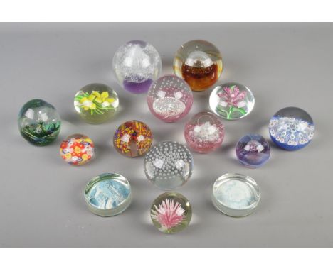 A collection of glass paperweights, to include bubble set, millefiori and Caithness Moon Crystal examples.