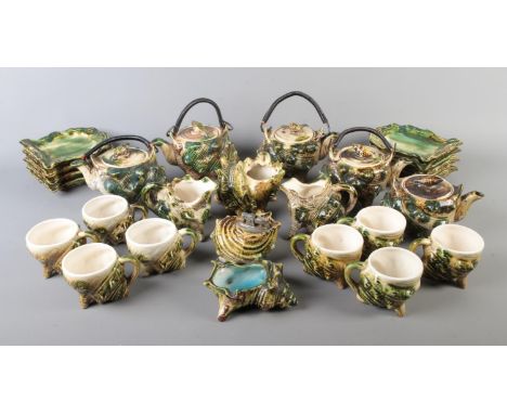 A majolica tea service formed as conch shells to include tea cups, table lighter, preserve pots, etc. Approx. 24 pieces.