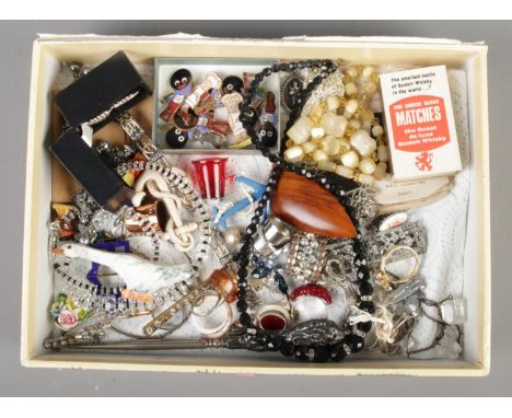 A box containing a quantity of collectables, to include Golly sporting badges, silks, dress rings, brooches and fern earrings