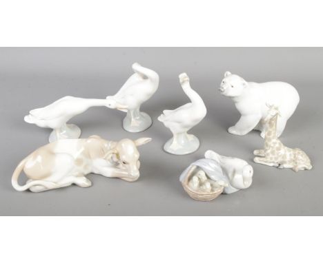 A good collection of seven Lladro ceramic animal figures to include Giraffe calf, Polar Bear, Geese and Cow calf.