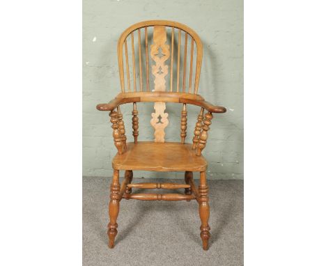 An ash/elm Windsor pad arm chair. Having bobbin turned arm supports.