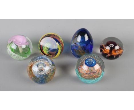 Six Caithness glass paperweights. Includes Sunflower, Time Tunnel, Calypso, Energize, Origin and Cosmos.