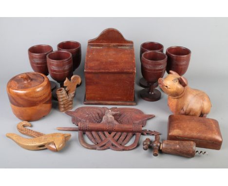 A collection of treen including tobacco jar, salt box, nutcracker, corkscrew, carved bird plaque etc