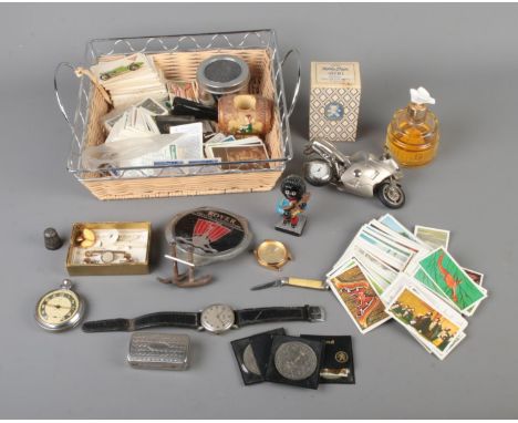 A small tray of collectables to include Ingersoll Triumph pocket watch, Robertson's Golly figure, Avon perfume bottles, Brook