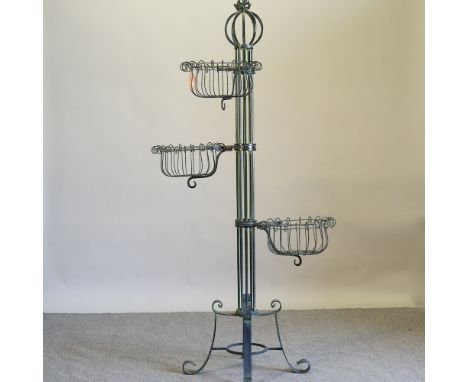 A green painted wrought iron three tier planter, 185cm high